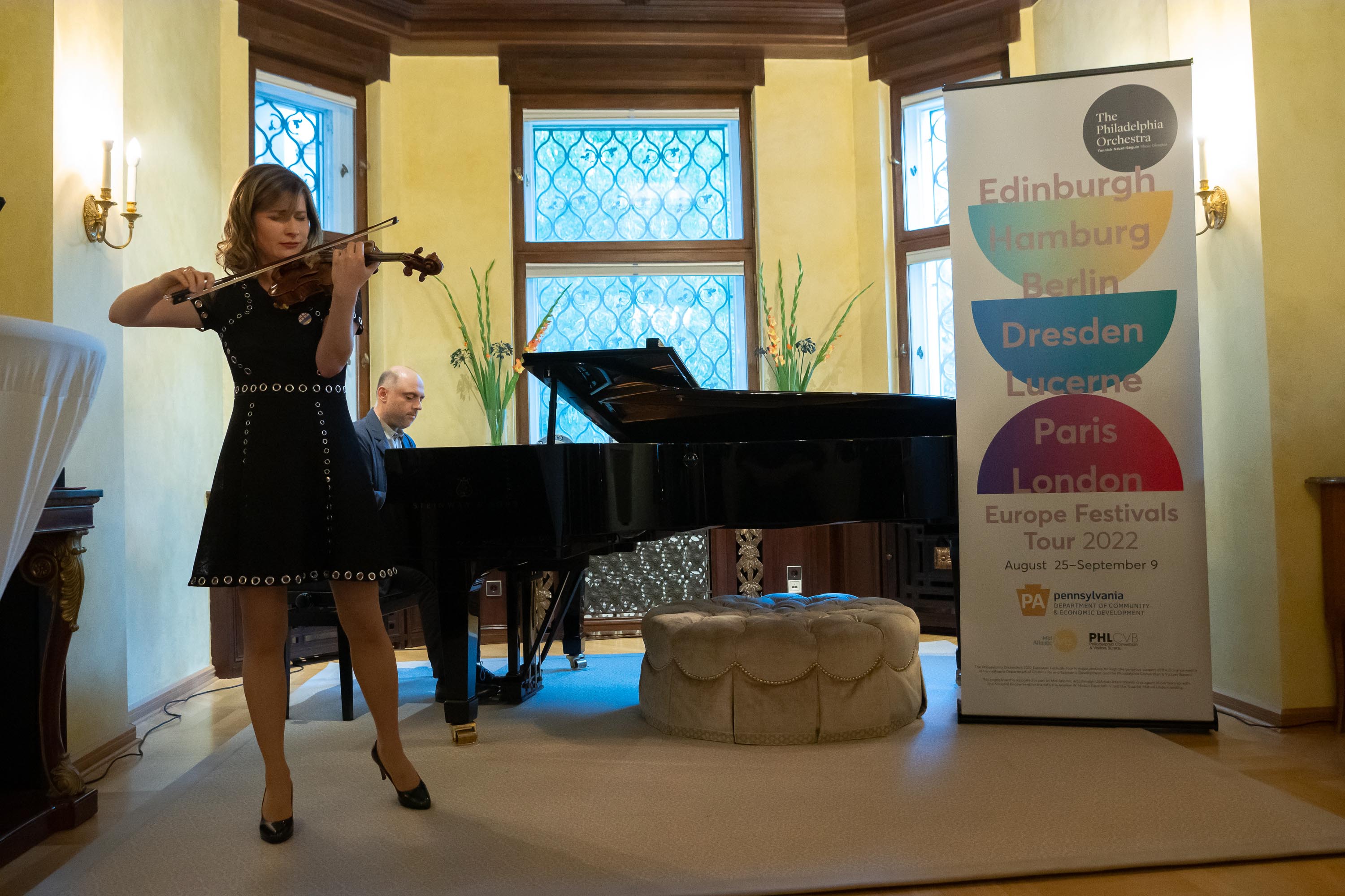 Violinist Lisa Batiashvili, one of the soloists on the tour, performs for the guests with her accompanist