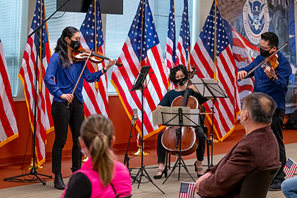 Orchestra musicians performing at a naturalization ceremony