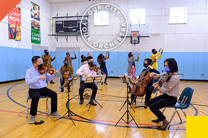 Musicians and UrbanPromise Fellows performing in a gymnasium